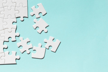 Jigsaw puzzle white piece on blue backdrop