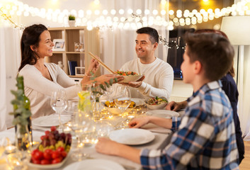 celebration, holidays and people concept - happy family having dinner party at home