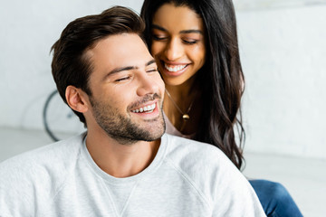 smiling african american woman and handsome man with closed eyes