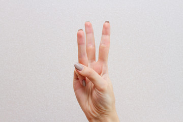 hand showing up 3 fingers  gesture in sign language 