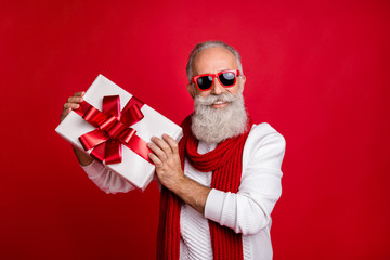Cool aged santa like man came meeting newyear with large giftbox wear sun specs knitted jumper...
