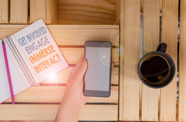 Word writing text Get Involved Engage Immerse Interact. Business photo showcasing Join Connect Participate in the project woman computer smartphone drink mug office supplies technological devices