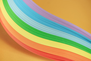 Beautiful rainbow color ribbon on orange background.