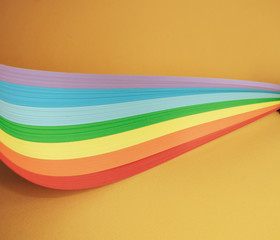Beautiful rainbow color ribbon on orange background.