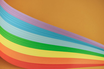 Beautiful rainbow color ribbon on orange background.