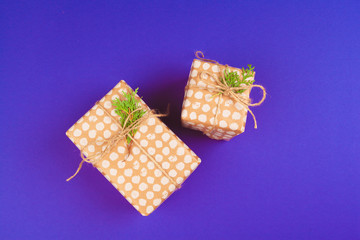 Gift box on purple background top view