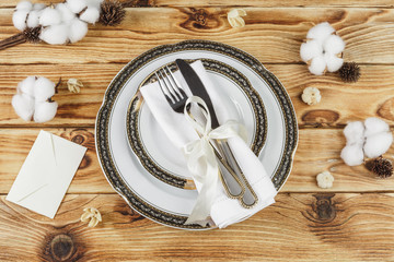 Beautiful table setting on wooden table from above