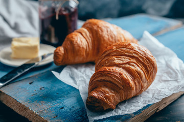 close up of delicious croissants on wooden table