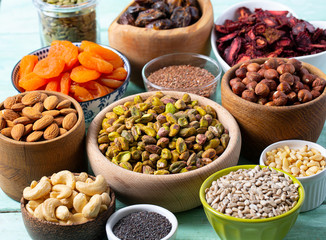nuts, seeds and dried fruis on wooden surface