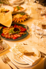 Table setting set with flowers. Modern and elegant decorated banquet table with different food.