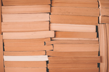 Old books stacked in book store closeup. Selective focus.