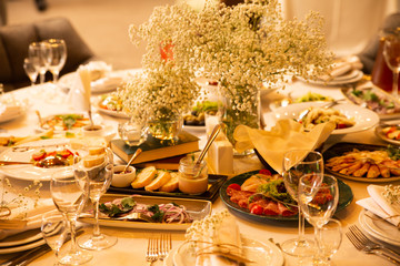 Table setting set with flowers. Modern and elegant decorated  banquet table with different meal food.