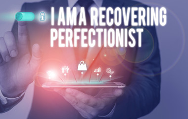 Text sign showing I Am A Recovering Perfectionist. Business photo text Obsessive compulsive disorder recovery Male human wear formal work suit presenting presentation using smart device