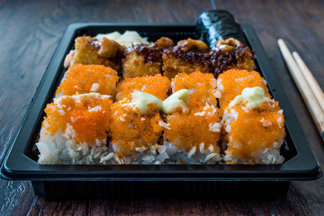 Sushi Set in Plastic Container Box / Package. California Roll, New York Roll, Boom Roll, Ginger, Wasabi and Soy Sauce.