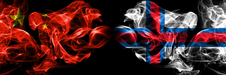 China vs Faroe Islands smoke flags placed side by side. Thick colored silky smoke flags of Chinese and Faroe Islands