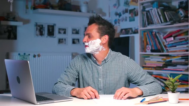 Stress in the home office of a coronavirus infection COVID-19. Multitasking. Cheerful office worker at the table shows like.