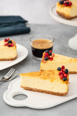 Sliced cheesecake with a glass of coffee.