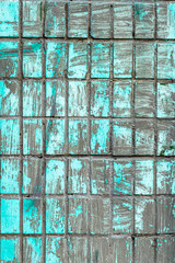 dirty turquoise crumbling wall tile as texture for background	