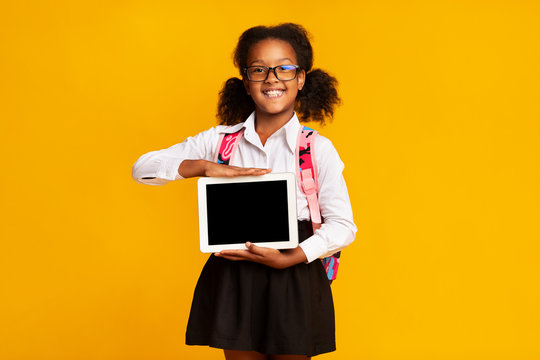 African American Schoolgirl Hodling Tablet Computer With Blank Screen