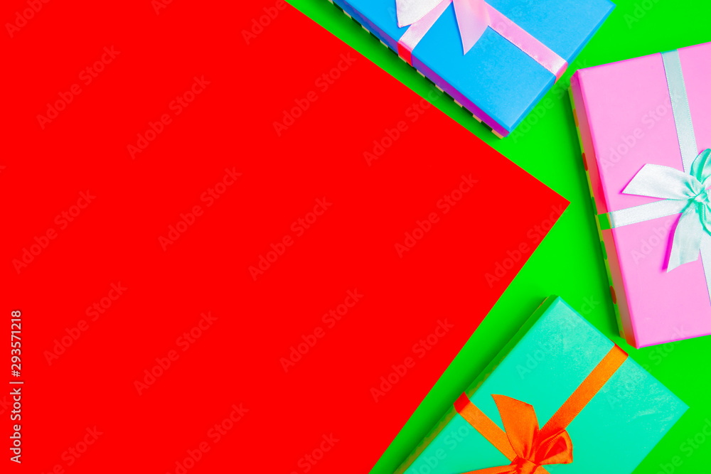 Aufkleber colored boxes with ribbons on a colorful background. view from above.
