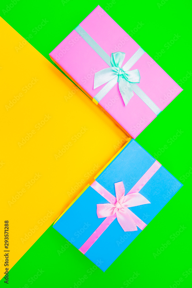Aufkleber colored boxes with ribbons on a colorful background. view from above.