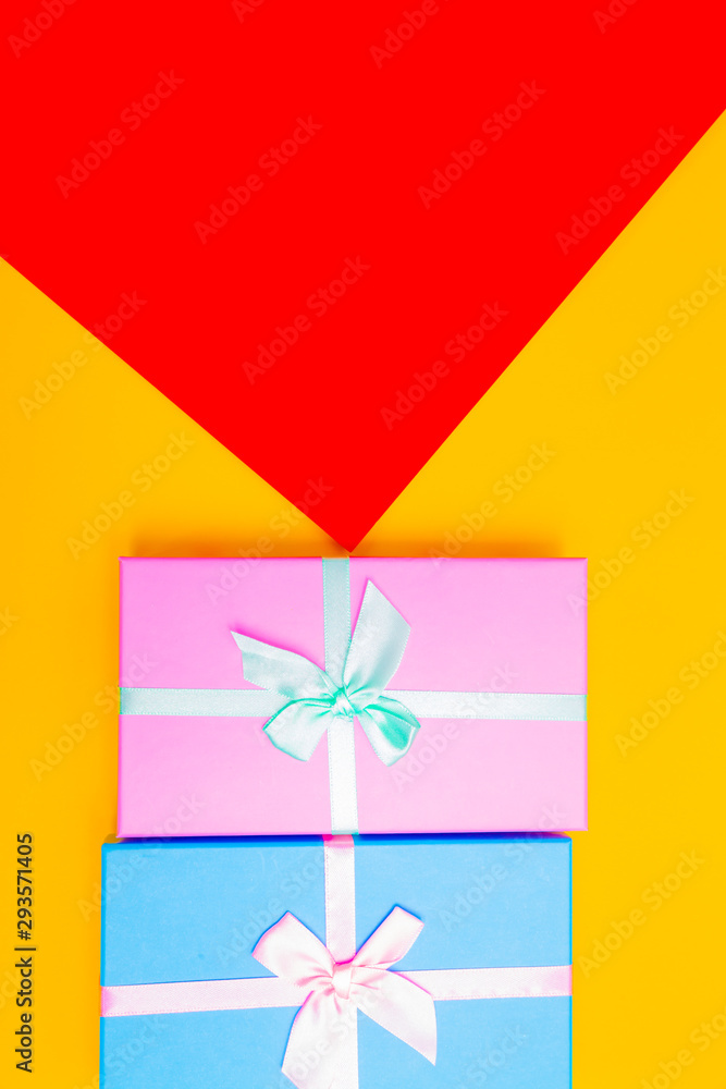 Aufkleber colored boxes with ribbons on a colorful background. view from above.
