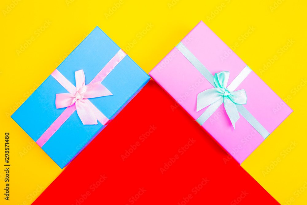 Aufkleber colored boxes with ribbons on a colorful background. view from above.