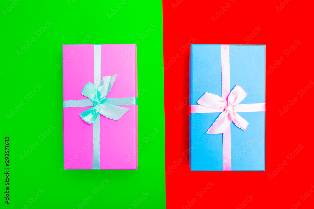 Aufkleber colored boxes with ribbons on a colorful background. view from above.