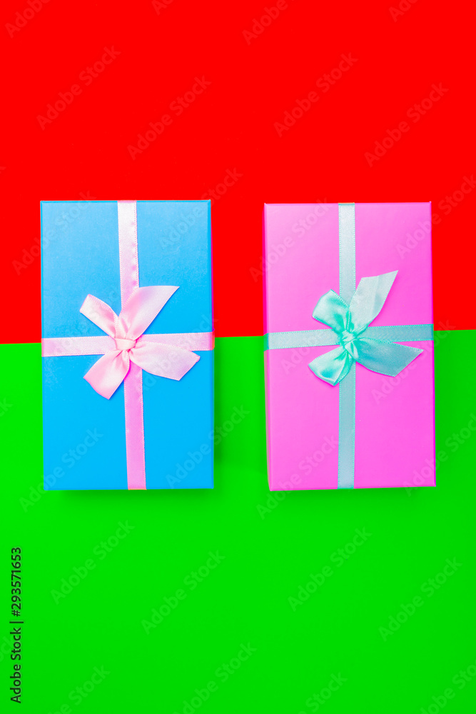 Aufkleber colored boxes with ribbons on a colorful background. view from above.