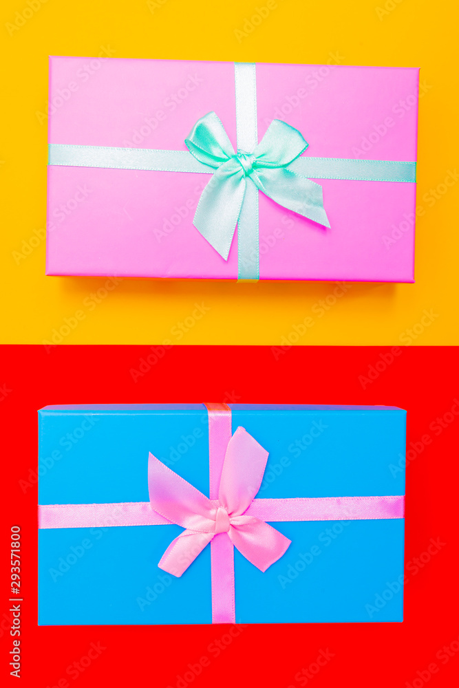 Aufkleber colored boxes with ribbons on a colorful background. view from above.