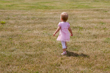 Little girl walks across the field