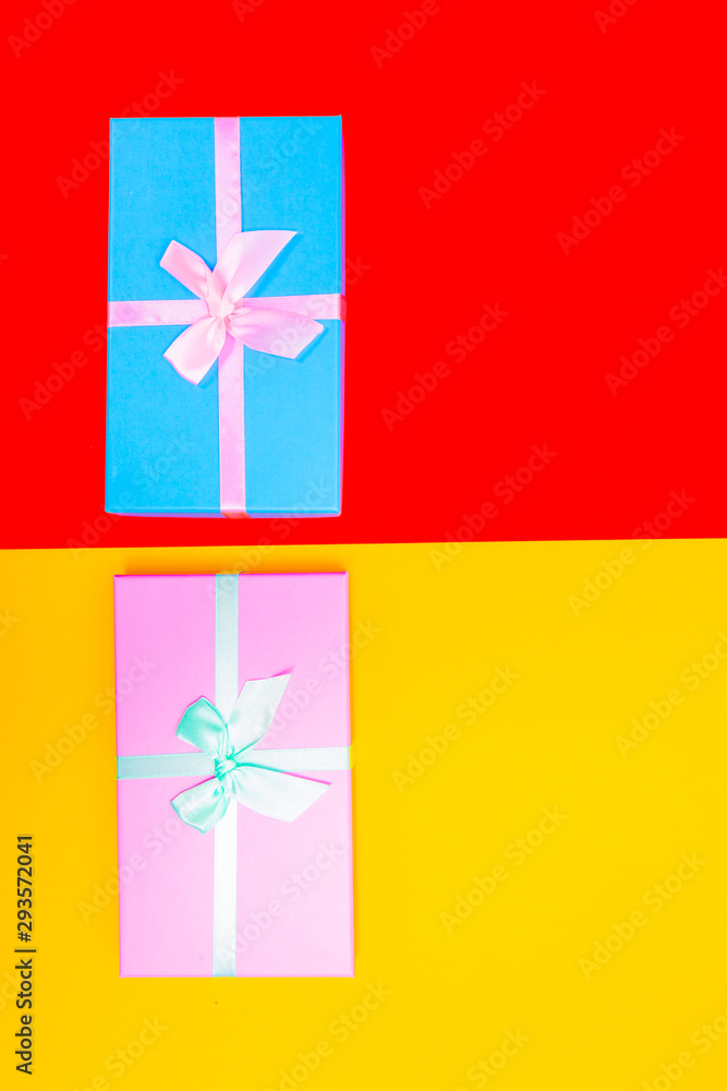 Poster colored boxes with ribbons on a colorful background. view from above.