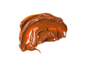 Melted tasty caramel splashes isolated on white background.