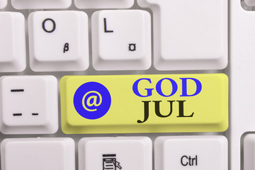 Writing note showing God Jul. Business concept for Merry Christmas Greeting showing for new year happy holidays White pc keyboard with note paper above the white background
