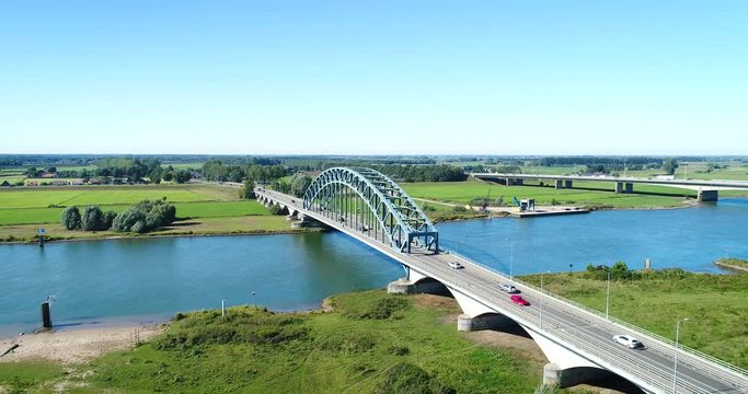 The Dutch IJssel River Near Zwolle With Two Bridges and Crossing Cars, The Netherlands, 4K Drone Footage