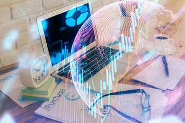 Double exposure of graph and financial info and work space with computer background. Concept of...