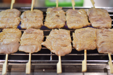 Grilled pork placed on the grill.