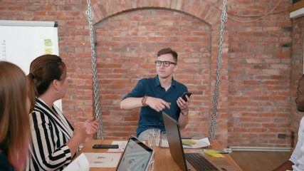 Business Man Team Leader or Trainer is Discussing Project to Employees in Startup Loft Office. Teamwork or Seminar in Diverse Group of People. Meeting at Work. 4K Gimbal Pull Out Shot