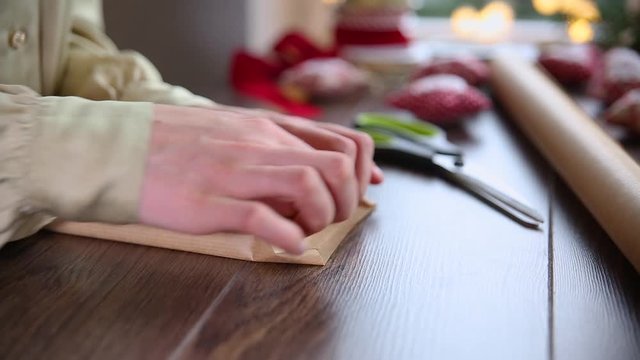 Close up on woman hands wrapping Christmas present