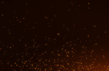 Abstract background of flickering gold particles and light flare