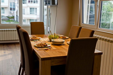 Served appetizing dinner of fried potatoes and green salad on a table, Sofia, Bulgaria  