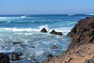 Waves rolling over rocks on shore