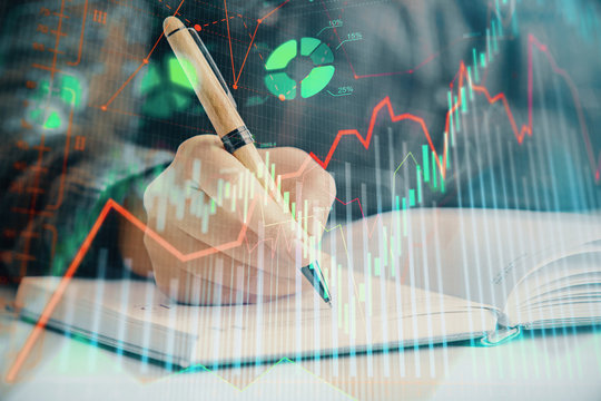Multi exposure of woman's hands making notes with forex graph hologram. Concept of technical analysis.