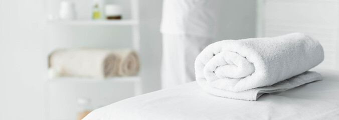 panoramic shot of white towel on massage mat in spa