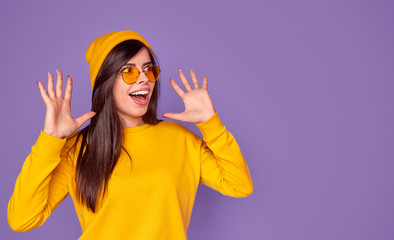 Stylish excited female on lilac background