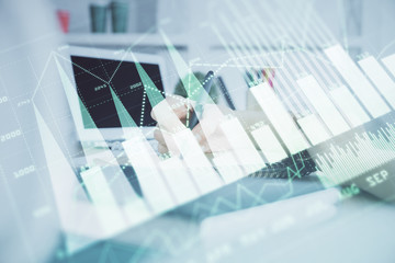 Fototapeta premium Financial graph displayed on woman's hand taking notes background. Concept of research. Double exposure