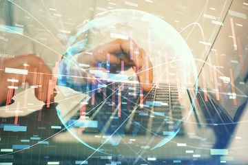 Double exposure of market chart with man working on computer on background. Concept of financial analysis.