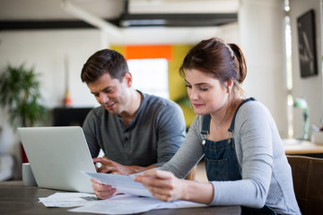 Young adult couple working on finance application together