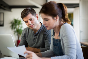 Young adult couple working on finance application together