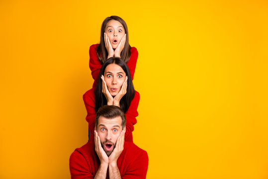Photo of excited crazy trendy cheerful cute funky positive family having built pyramid with their bodies astonished facial expression wearing red sweaters isolated over vivid color yellow background